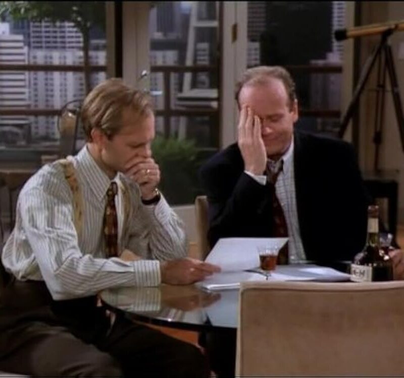Frasier-Niles-looking-at-a-manuscript